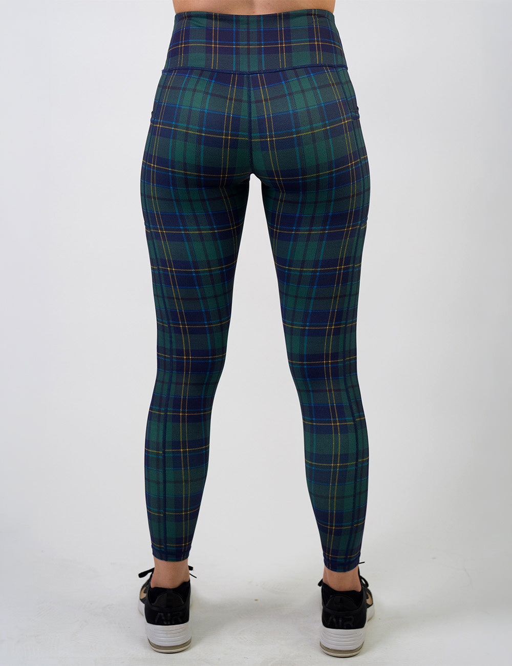 back of the blue, green, and yellow plaid full length leggings against a white background