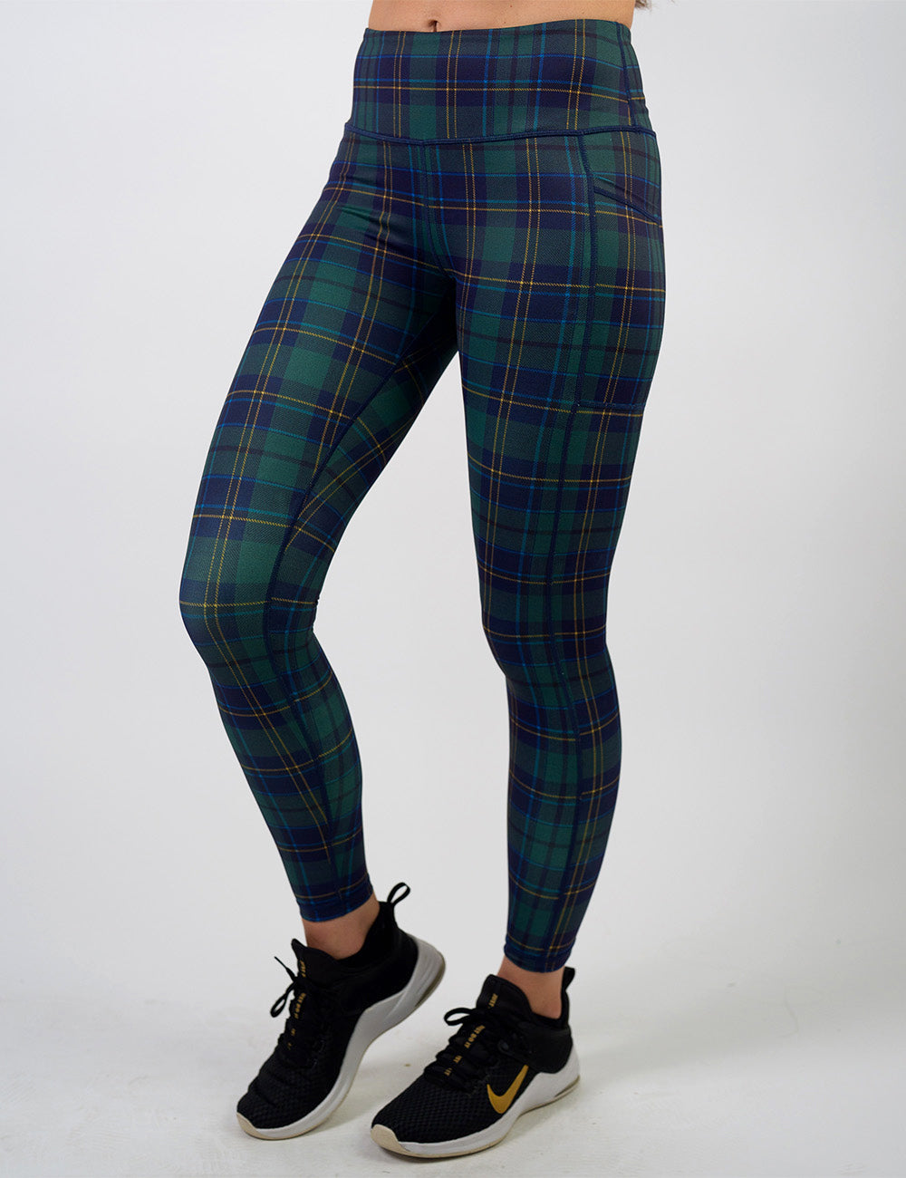 front of the blue, green, and yellow plaid full length leggings against a white background