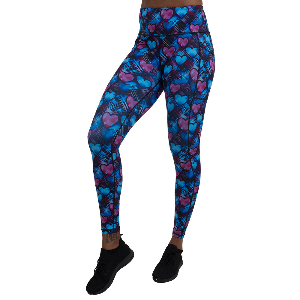 blue and pink hearts pattern against a dark stitched background full length leggings against a white background