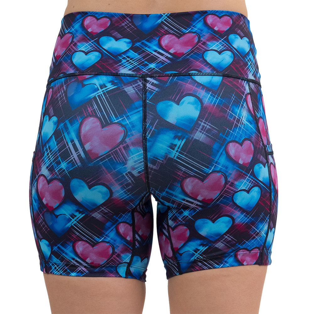 back of the blue and pink hearts pattern against a dark stitched background 5 inch shorts against a white background