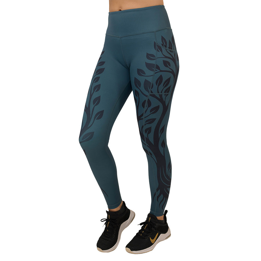 Teal leggings with black leaf pattern on a white background