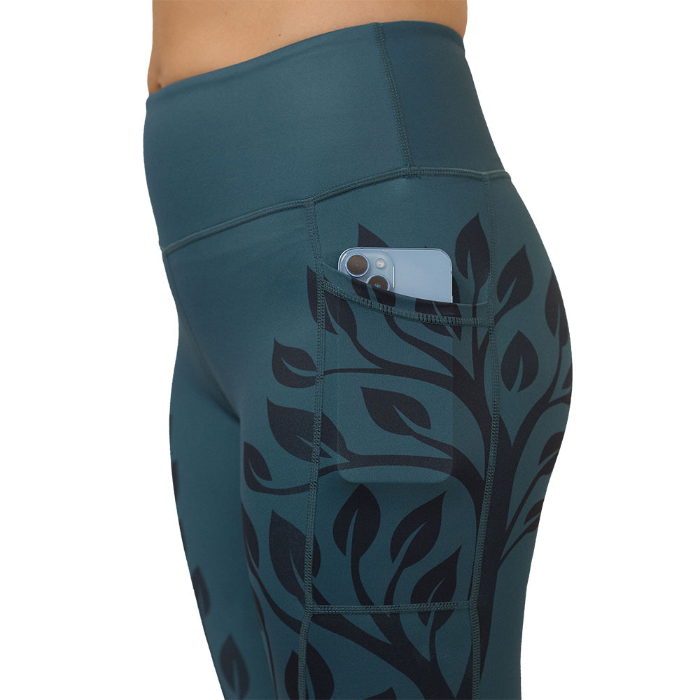 Teal leggings with black leaf pattern on a white background
