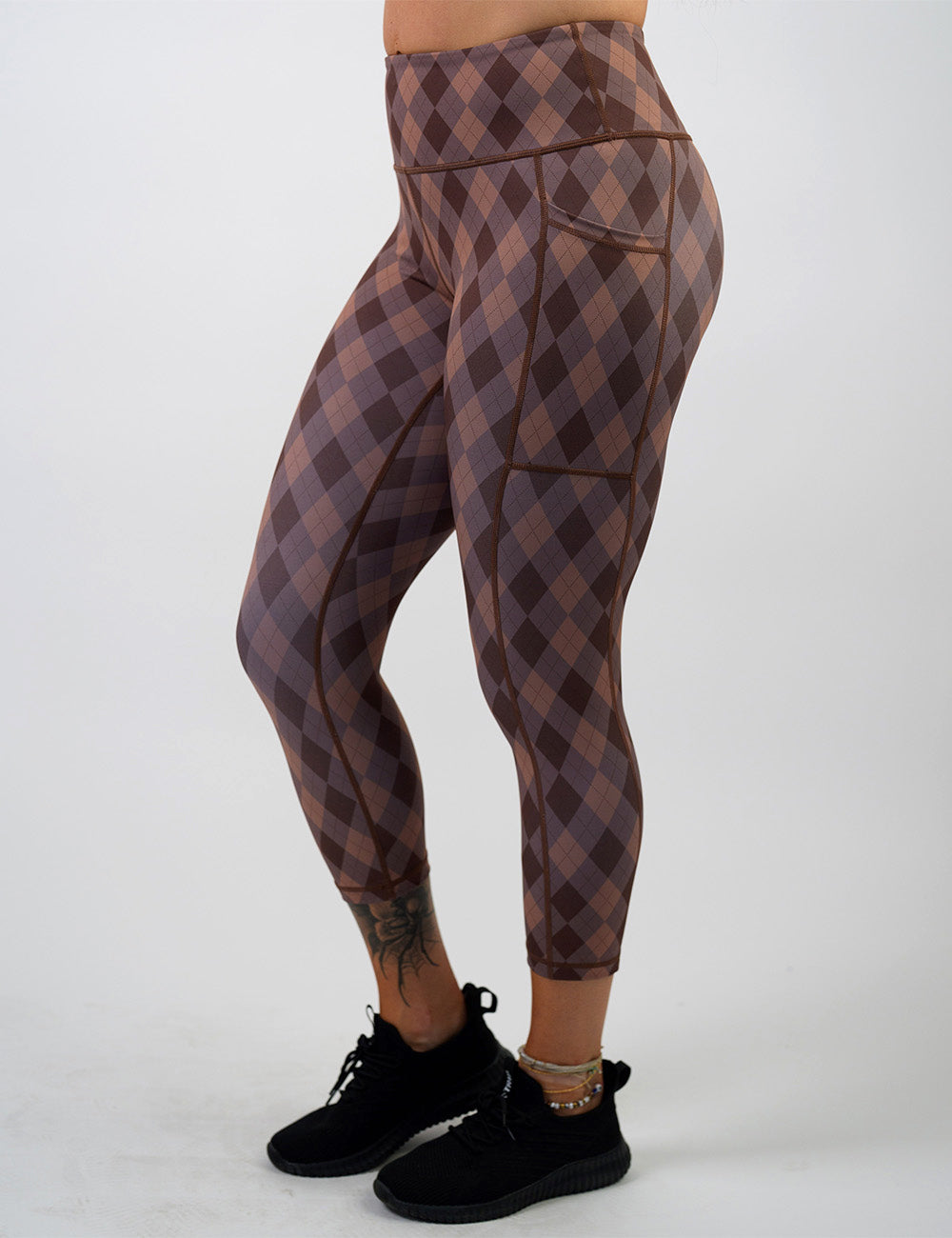 front of the capri grey, beige, and dark red plaid leggings against a white background