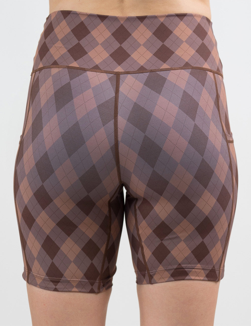 back of the 7 inch beige, grey, and brown plaid shorts against a white background