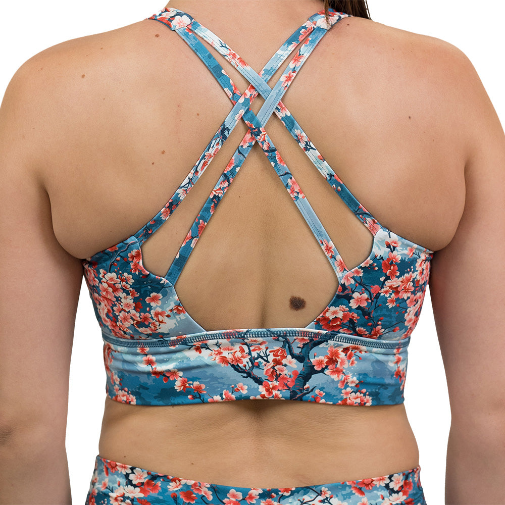 back of blooming cherry tree print longline bra against a white background