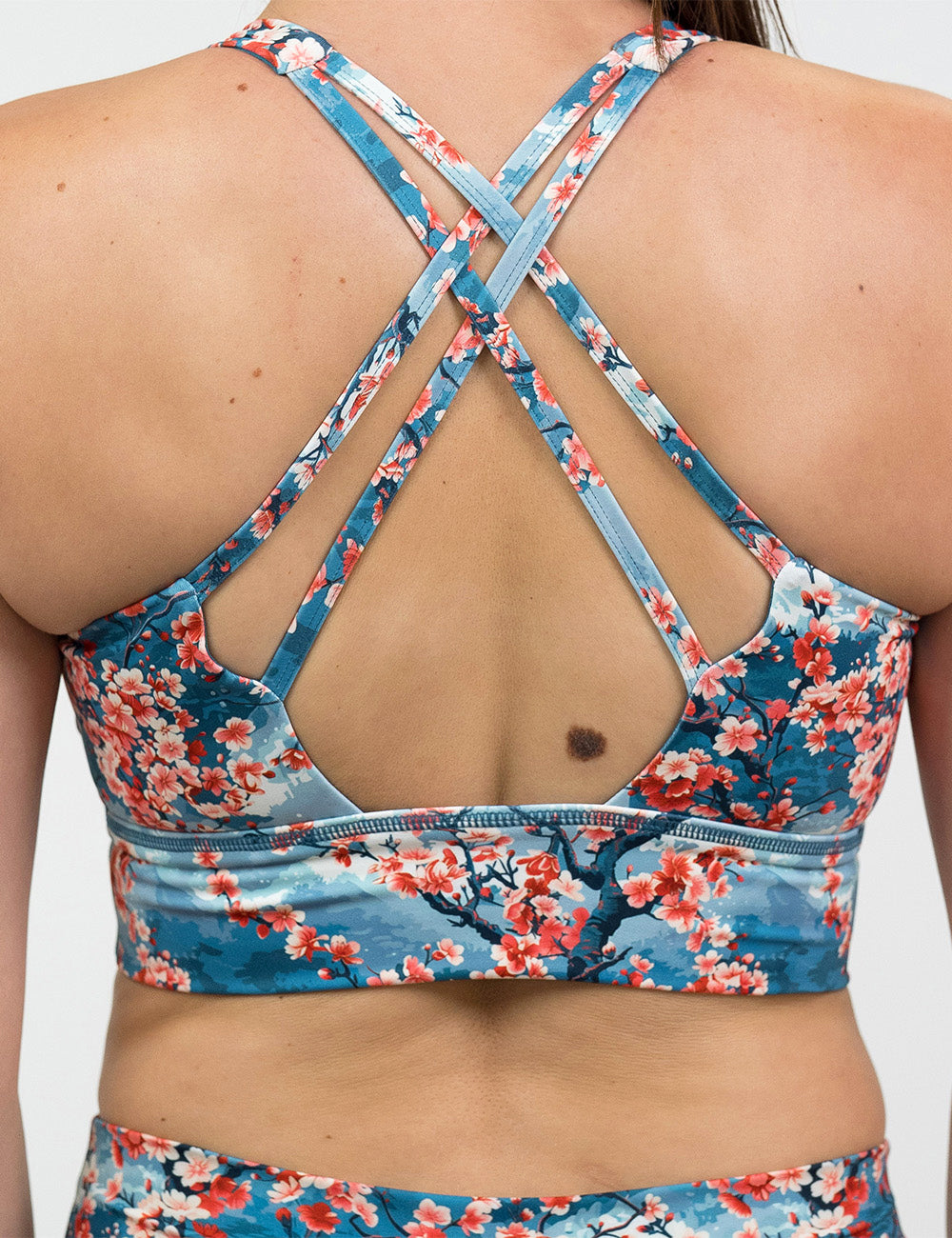 back of the blooming cherry tree print longline bra against a white background