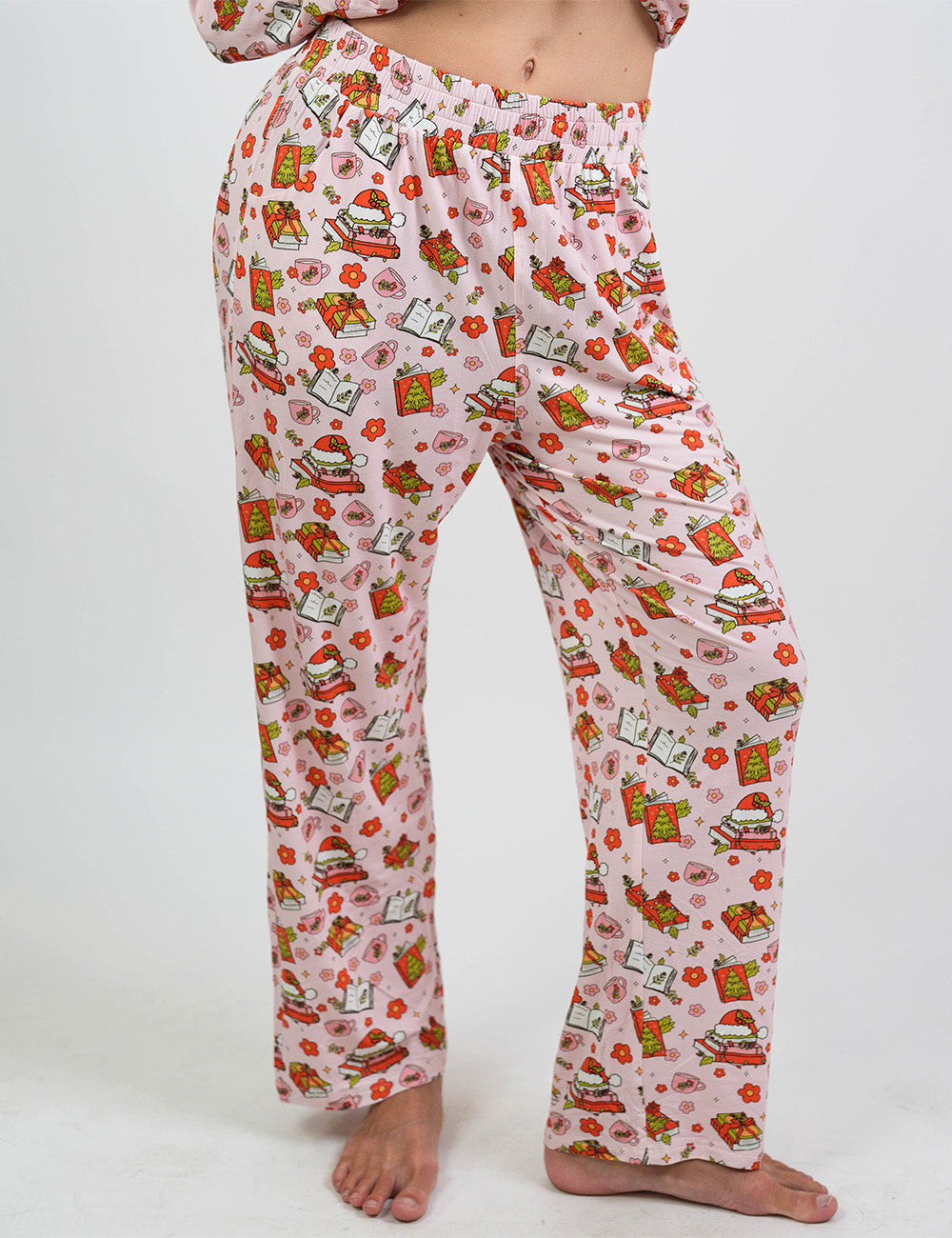 front of the Christmas books and flowers all over pink pajama bottoms against a white background