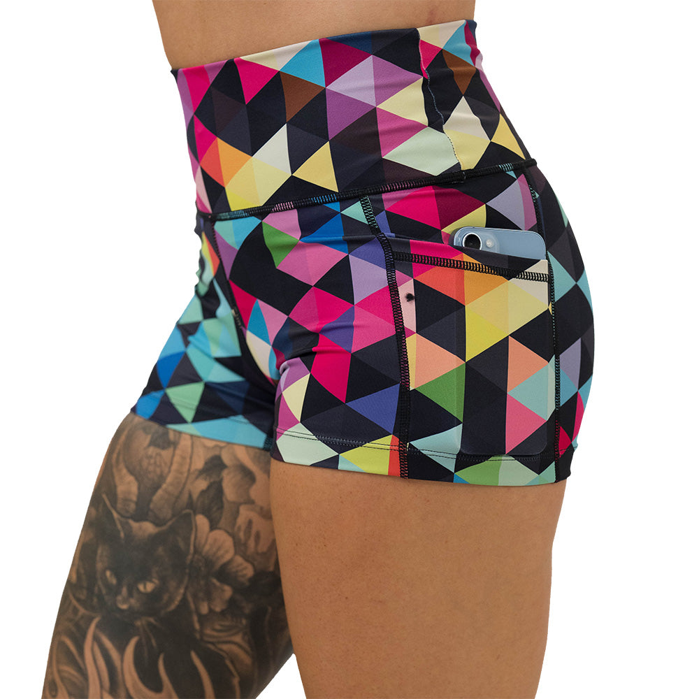 Colorful geometric patterned shorts on a white background