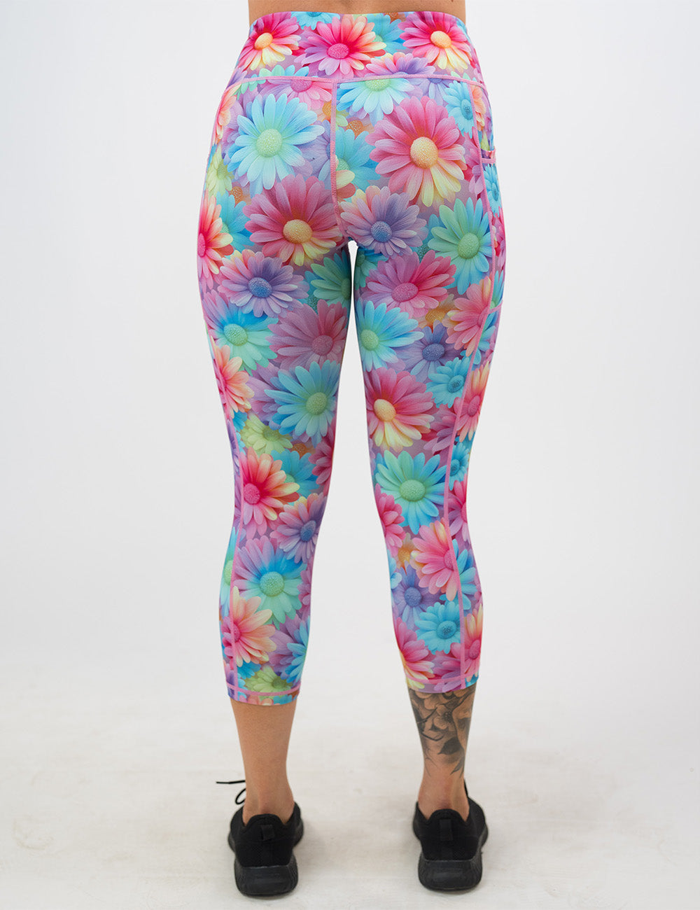 back of the colorful flower pattern capri leggings against a white background
