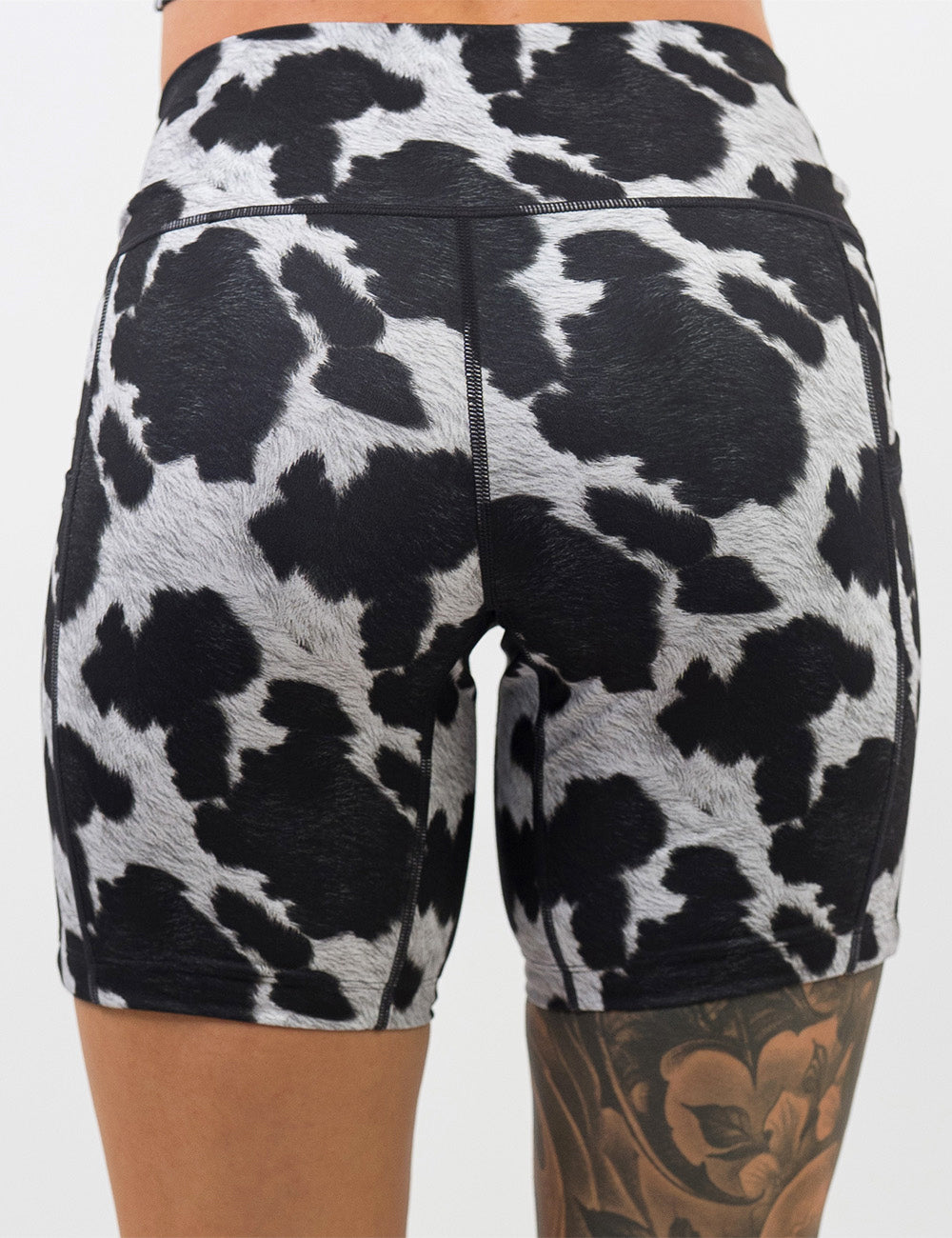 back of the 7 inch cow print shorts against a white background