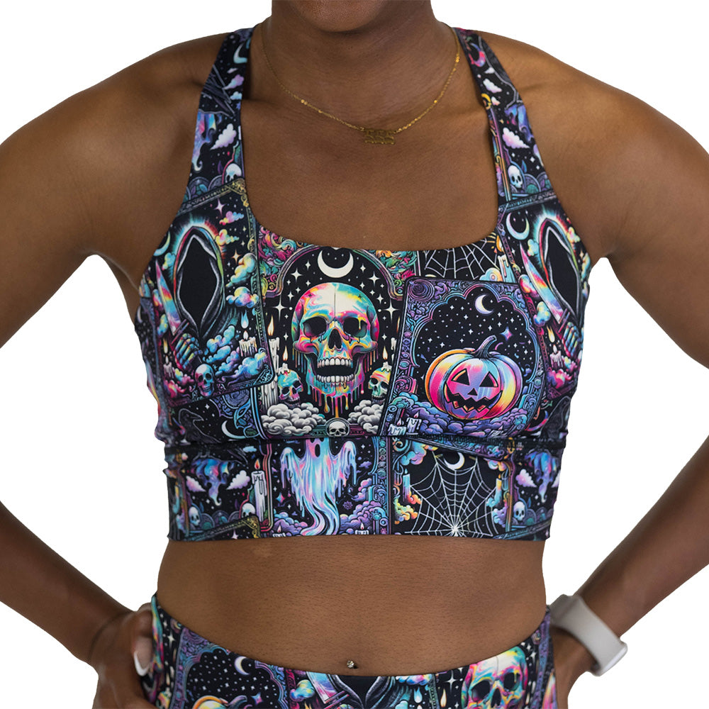 Person wearing a colorful Halloween-themed sports bra