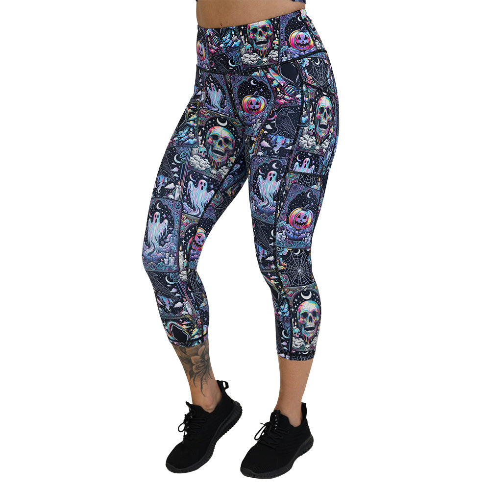 Colorful Halloween-themed leggings with skulls, ghosts, and pumpkins