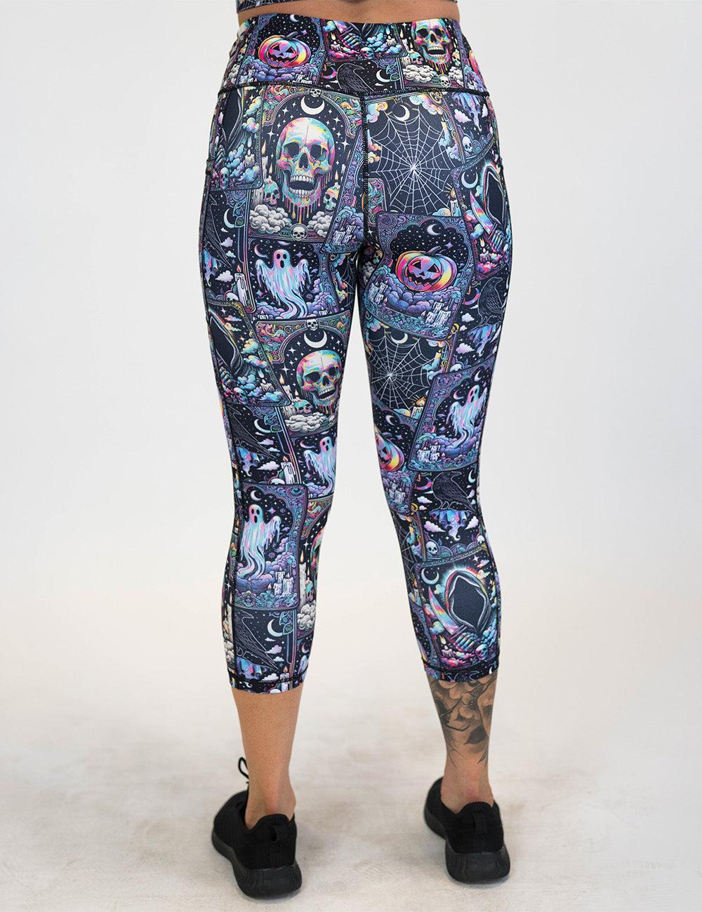 back of the rainbow skulls, jack o lantern, and ghosts capri leggings against a white background