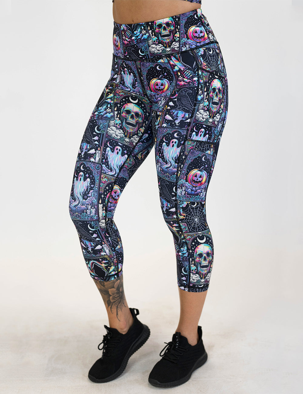front of the rainbow skulls, jack o lantern, and ghosts capri leggings against a white background