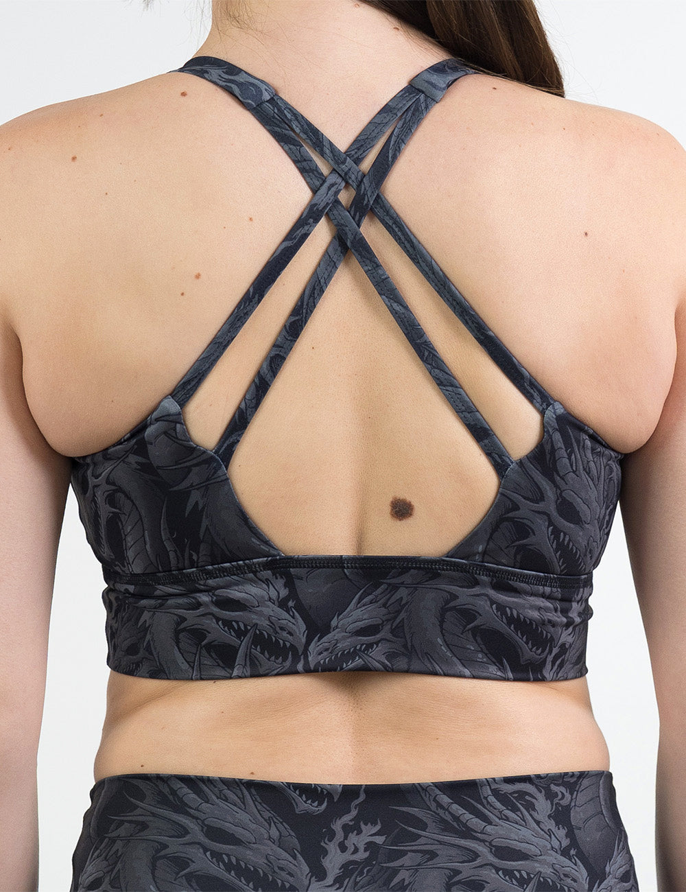 back of the black longline bra with a grey dragon pattern against a white background