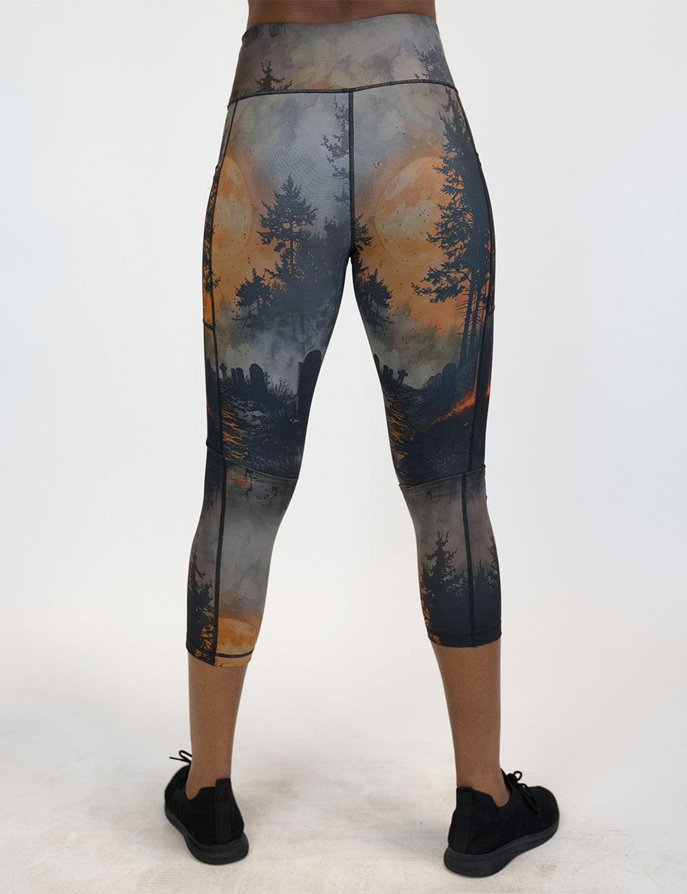 back of the capri dark cemetery with a full moon leggings against a white background