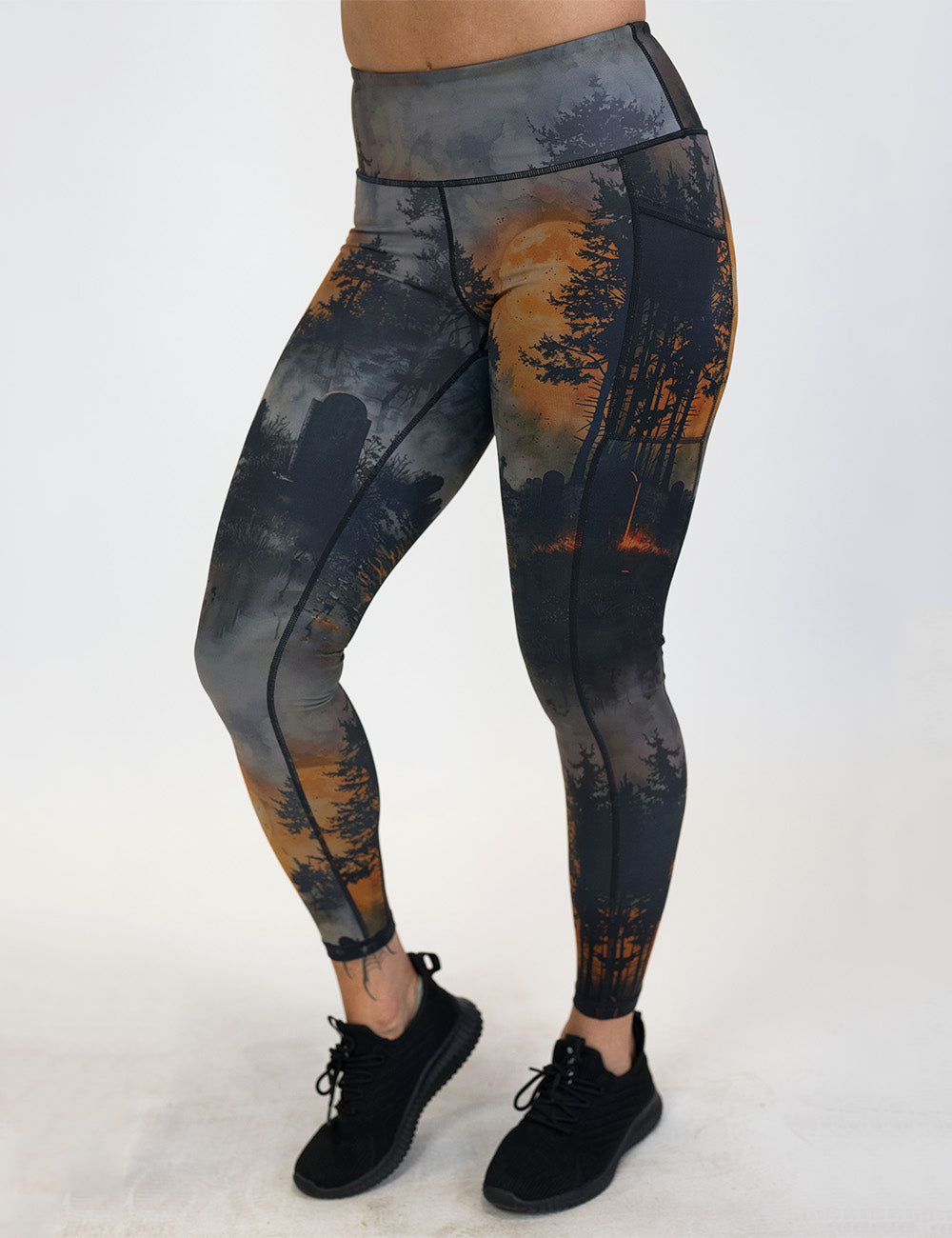 front of the dark cemetery with a full moon full length leggings against a white background