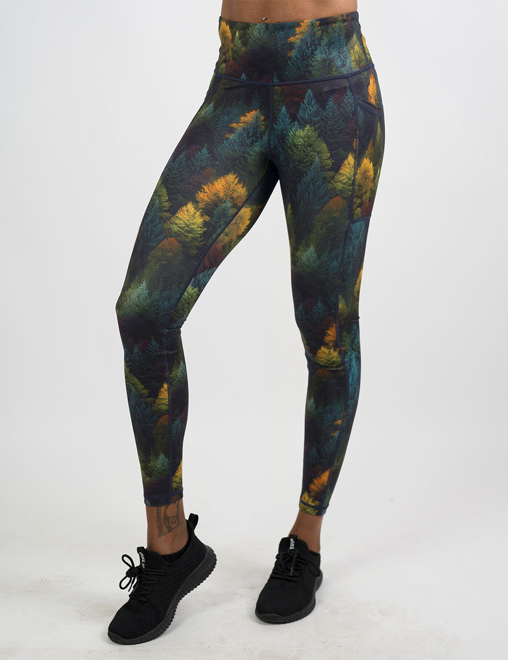 front of the orange, green, and bluish green trees full length leggings against a white background