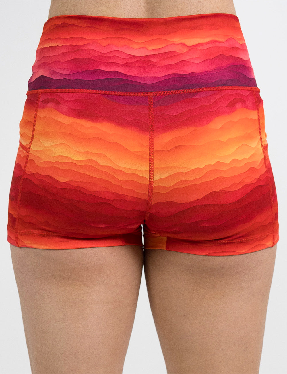 back of the 2.5 inch red, yellow, and orange sunset stripes pattern shorts against a white background
