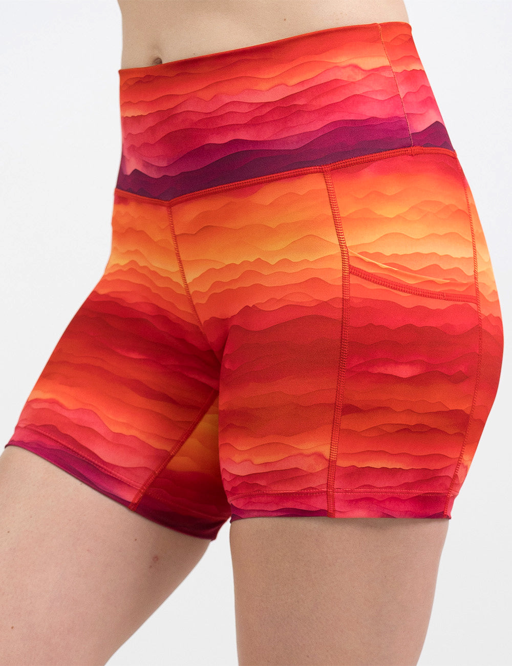 front of the 5 inch red, yellow, and orange sunset stripes pattern shorts against a white background