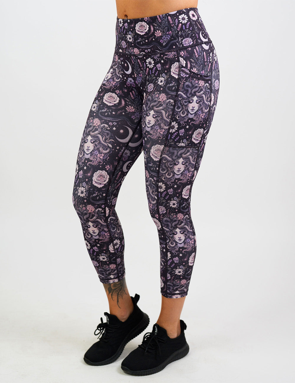 front of the purple medusa with flowers capri leggings against a white background