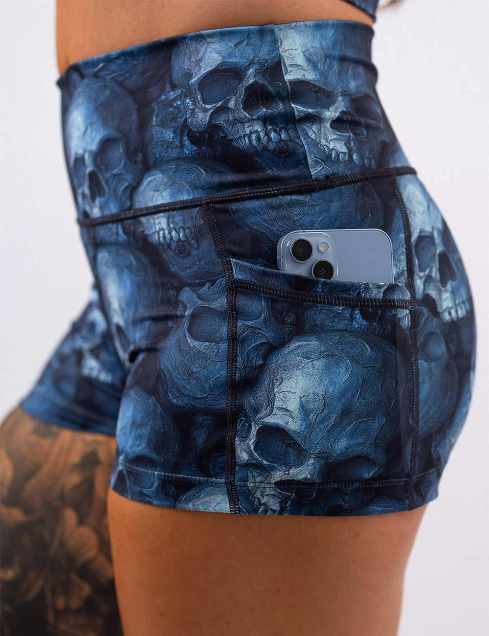 close up of the cool blue skulls shorts with a phone in its pocket