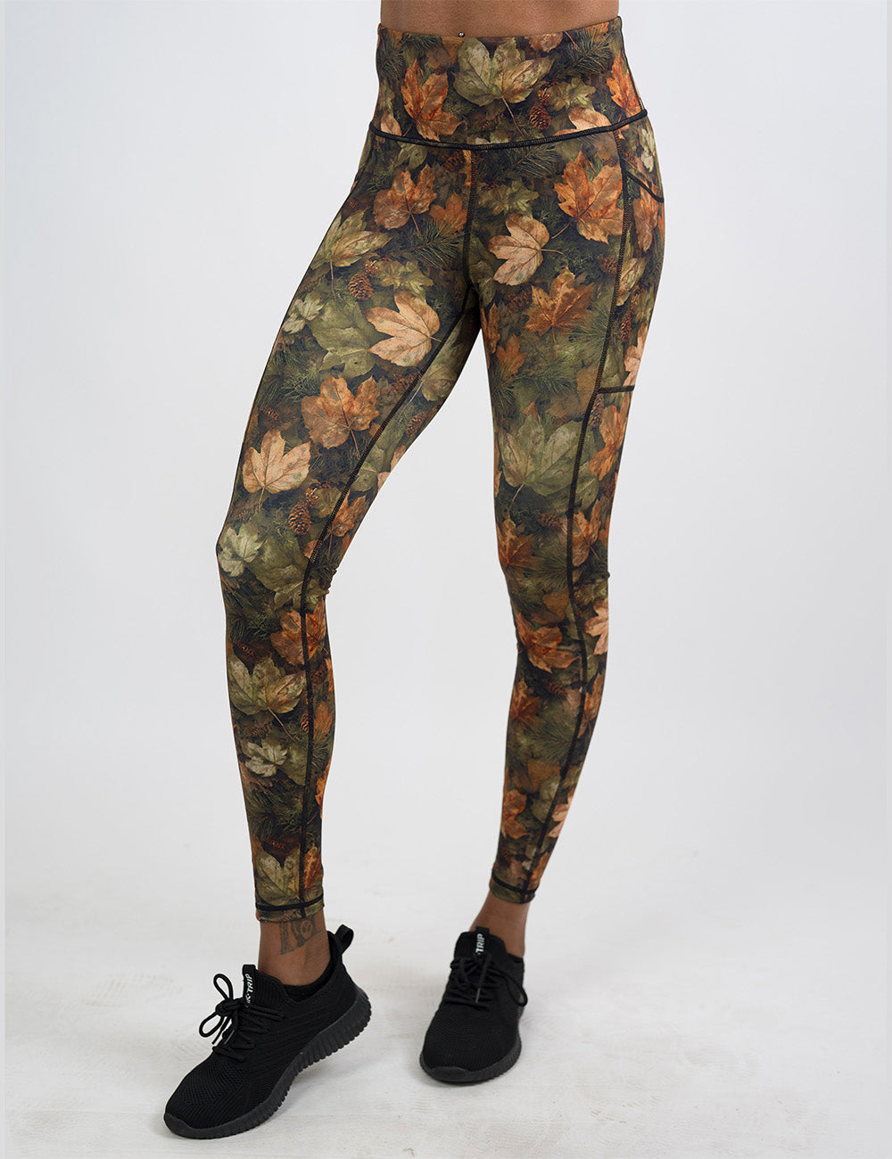 front of the full length forest floor covered in leaves leggings against a white background