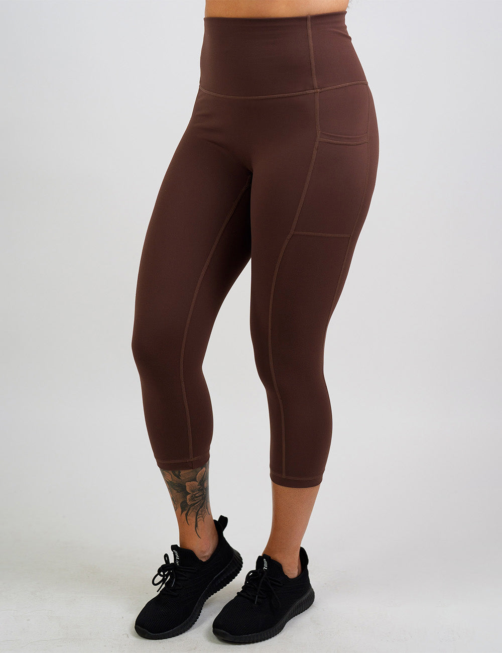front of the solid light brown capri leggings against a white background