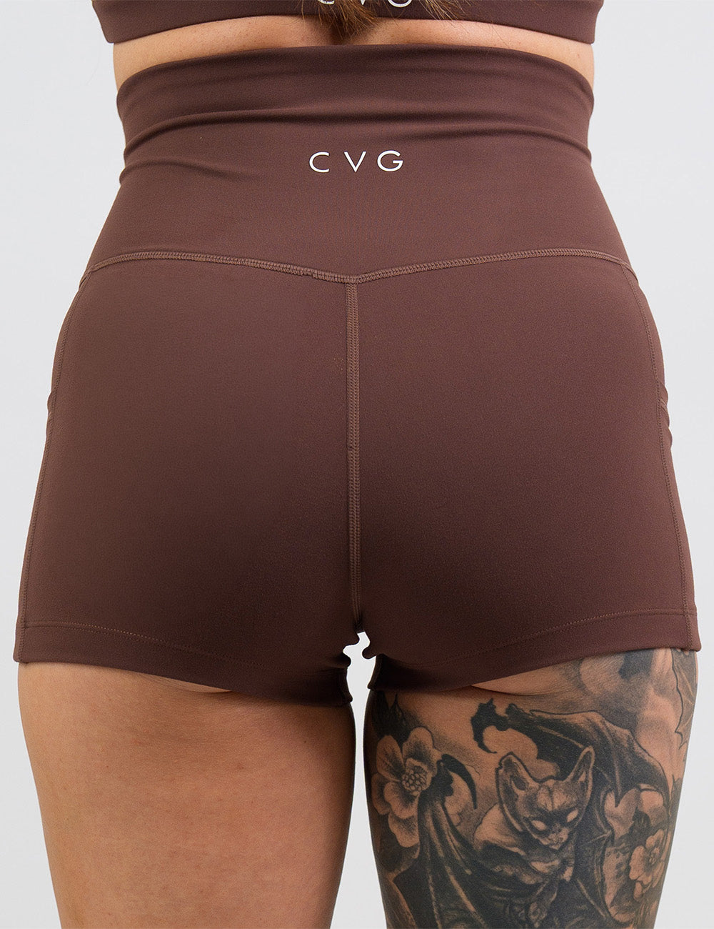 back of the 2.5 inch solid light brown shorts against a white background