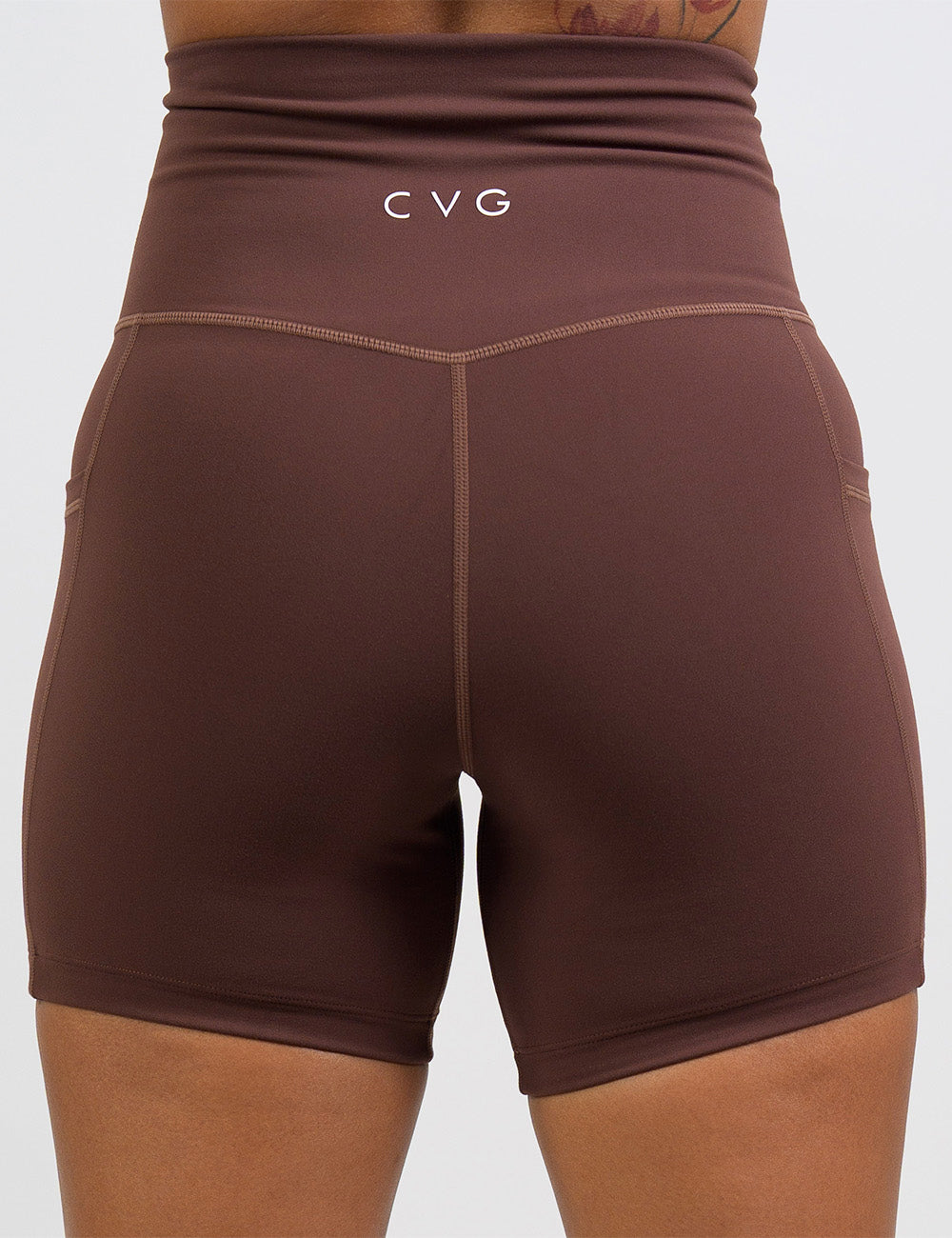back of the 5 inch solid light brown shorts against a white background