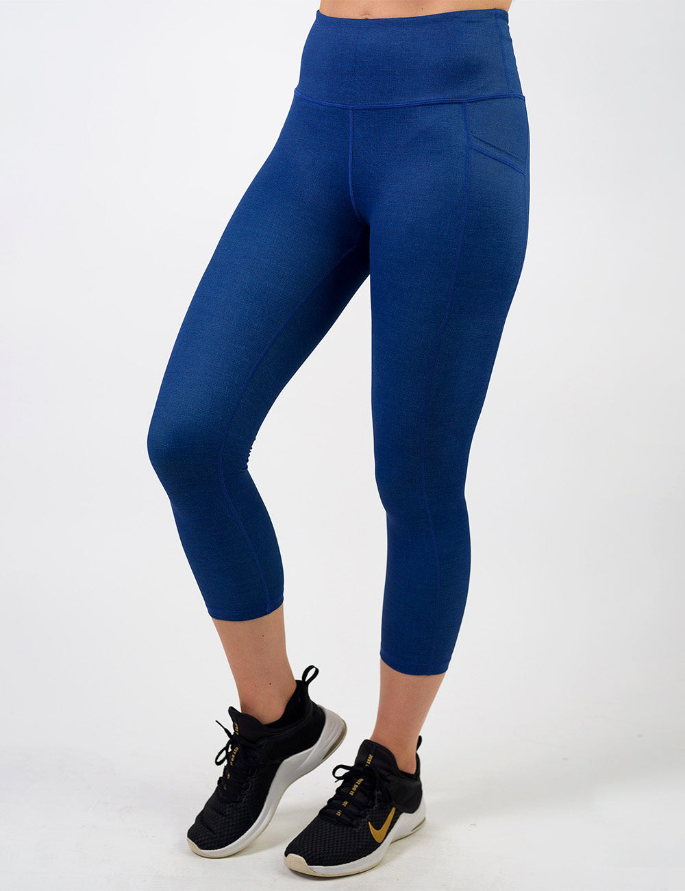 front of the blue denim inspired pattern capri leggings against a white background