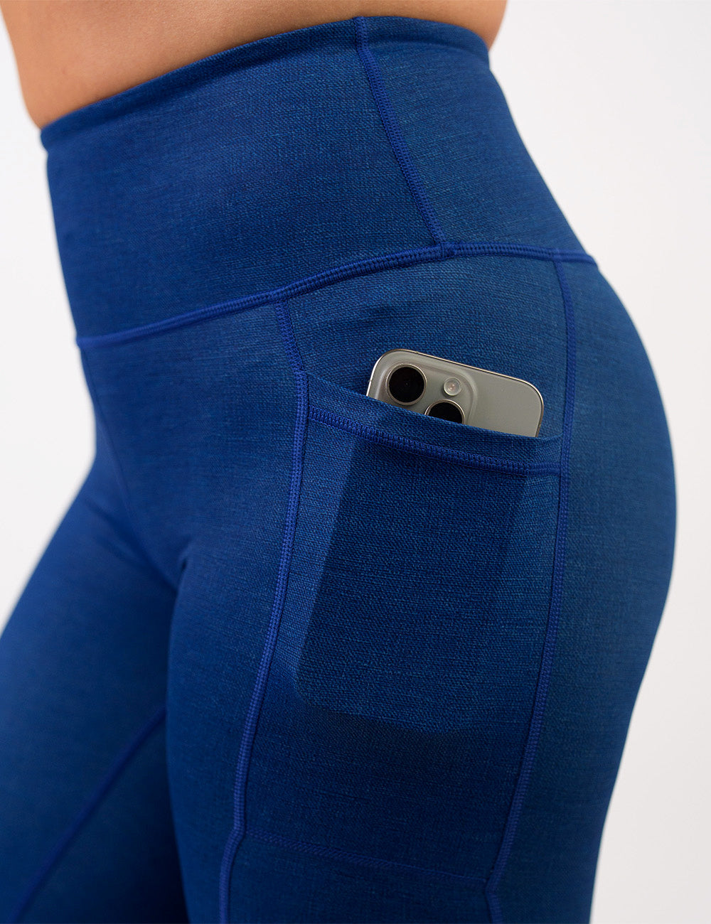 close up of the blue denim inspired pattern leggings with a phone in its pocket