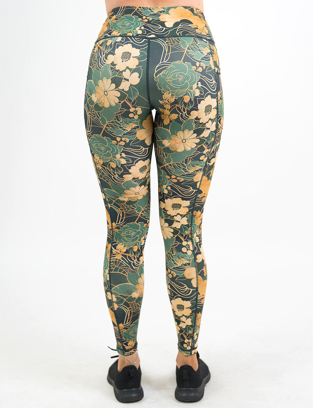 back of the full length gold and green flowers with gold accents pattern leggings