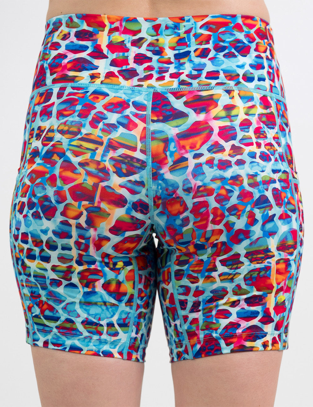 back of the 7 inch red, teal, and yellow mosaic style shorts against a white background