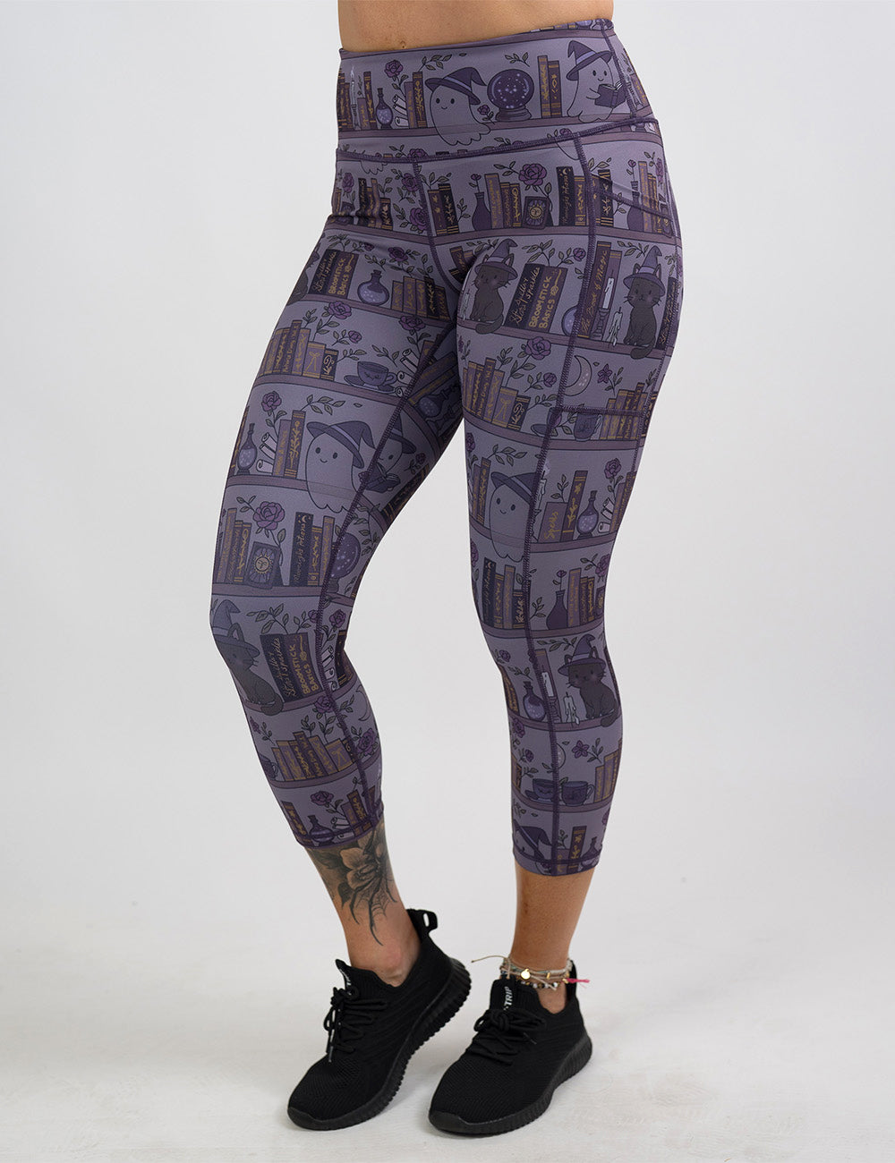 front of the ghosts and cats book shelves capri leggings against a white background