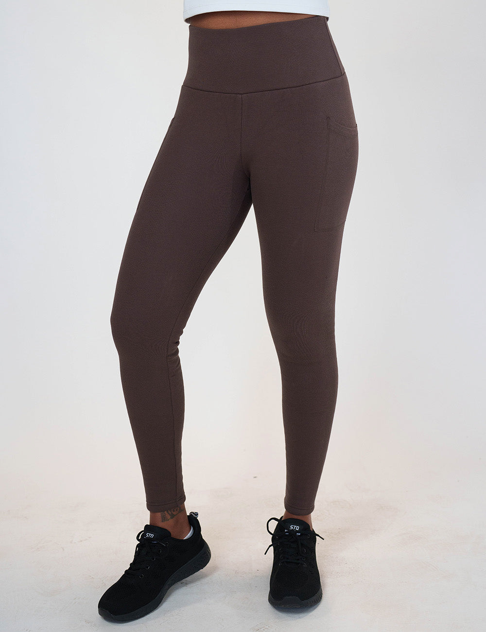 front of the solid brown fleece lined leggings against a white background