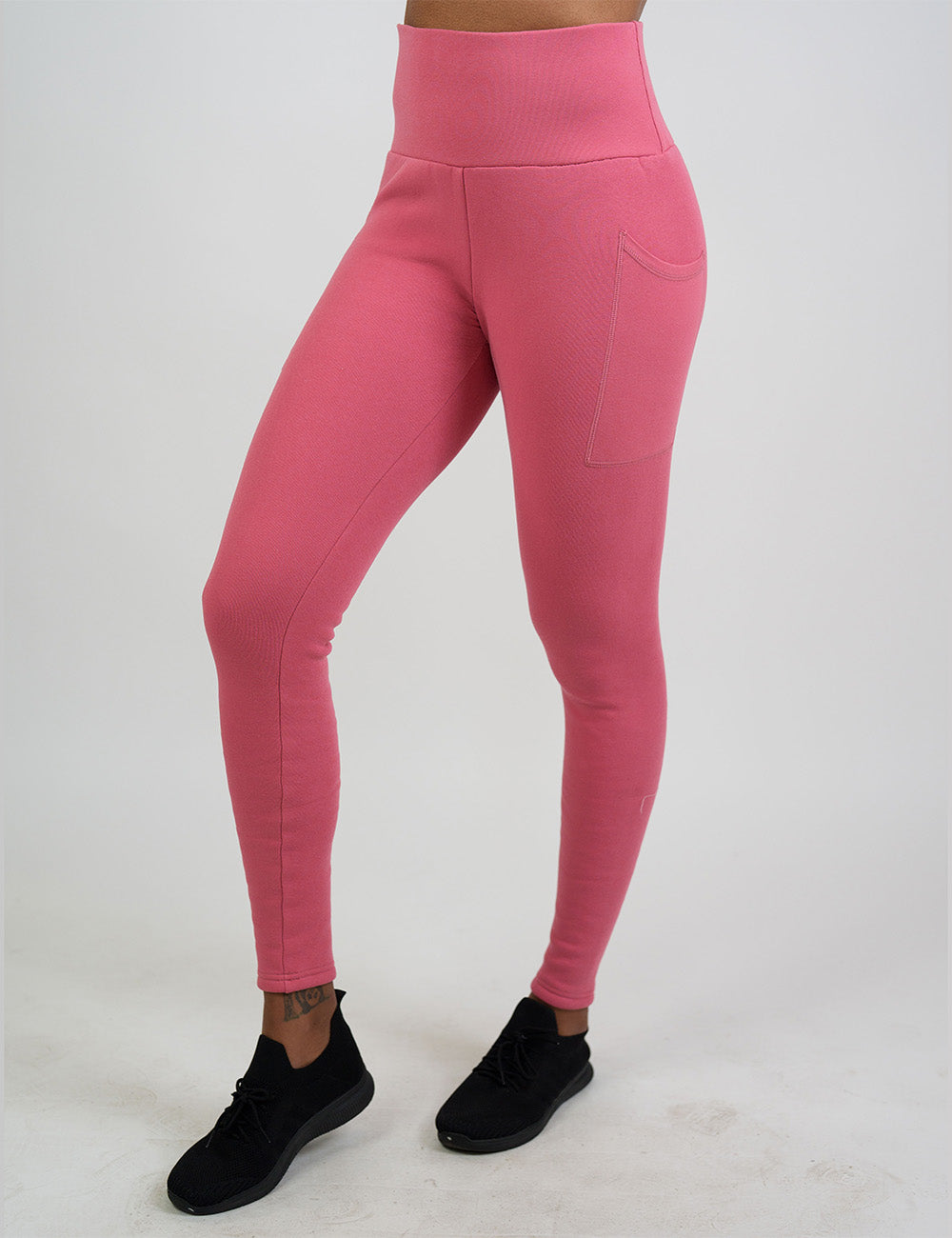 front of the solid pink fleece lined leggings against a white background