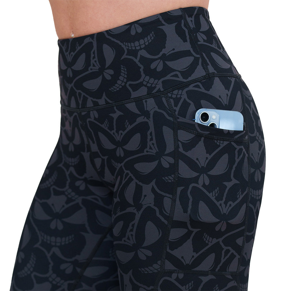 side pocket on the grey and black butterfly shaped skulls patterned leggings