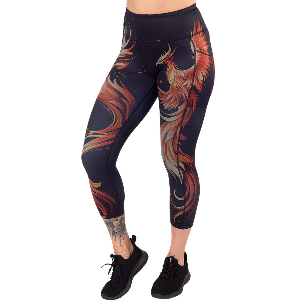 capri length black leggings with a red and orange phoenix graphic on it