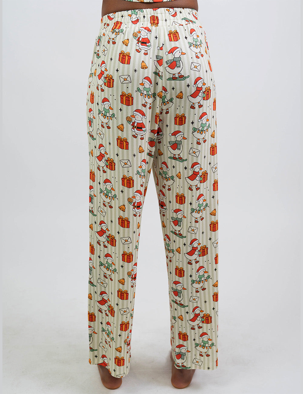 back of the ducks with santa hats surrounded by presents striped pajama bottoms against a white background