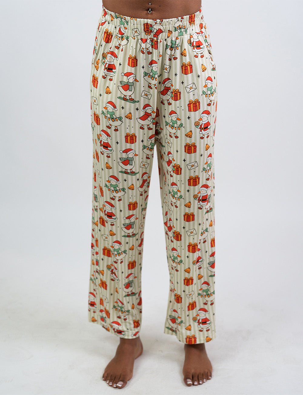 front of the ducks with santa hats surrounded by presents striped pajama bottoms against a white background