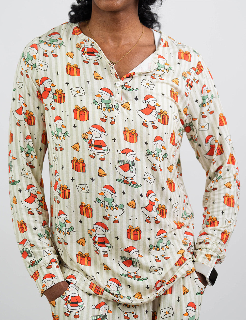 front of the ducks with santa hats surrounded by presents striped pajama top against a white background