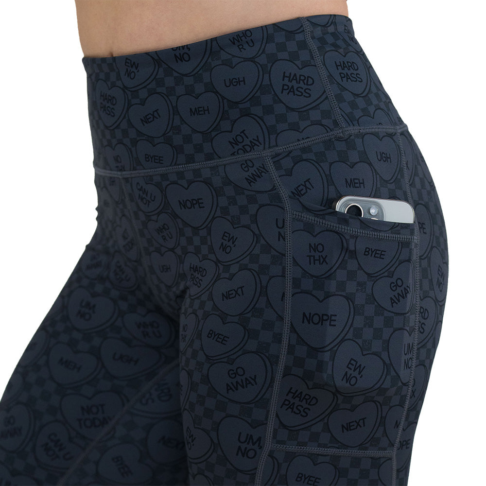 side pocket on the black and grey heart patterned leggings with a phone in the pocket