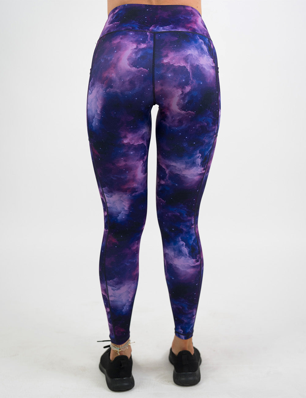 back of the full length purple space patterned leggings against a white background