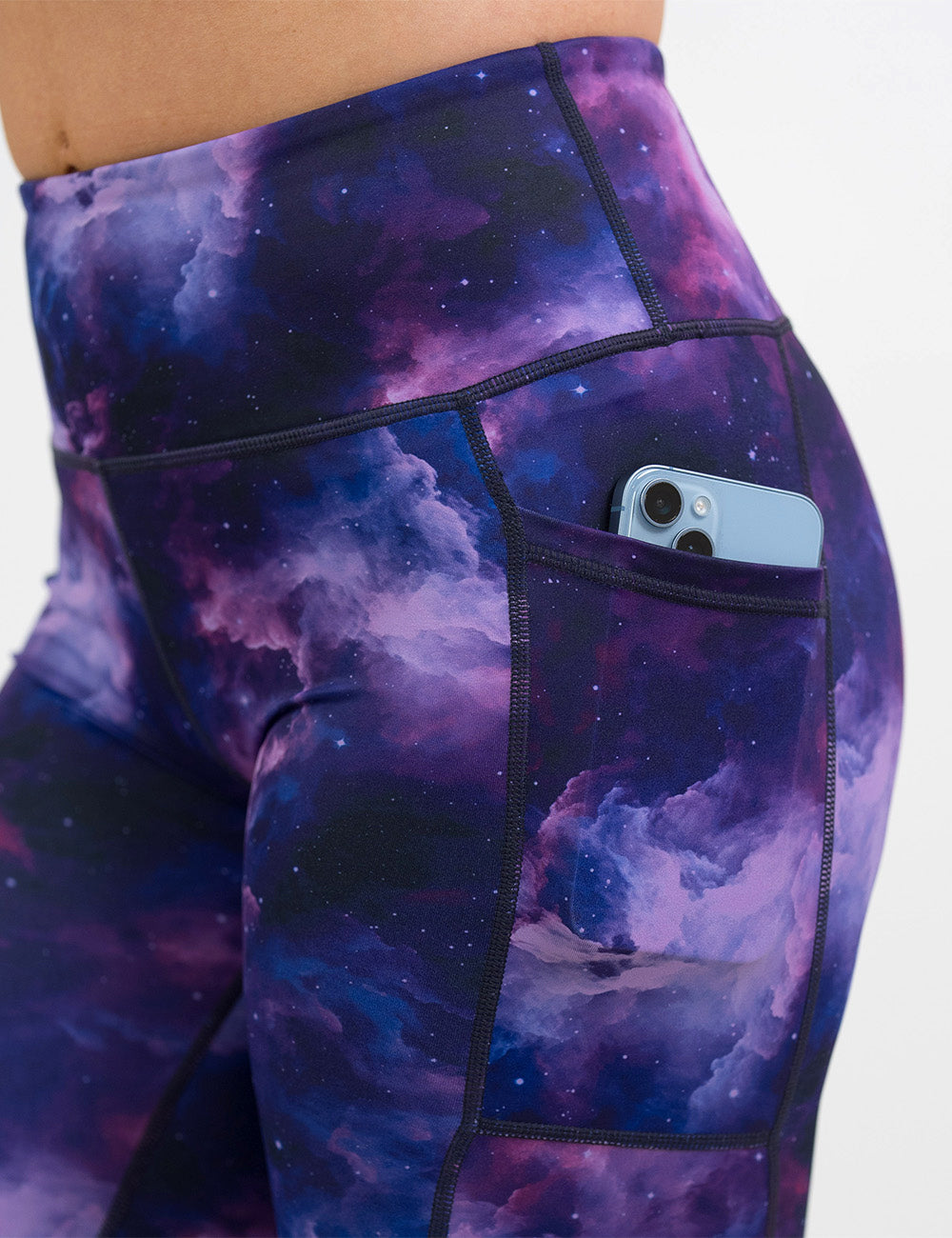 close up of the purple space patterned leggings with a phone in its pocket