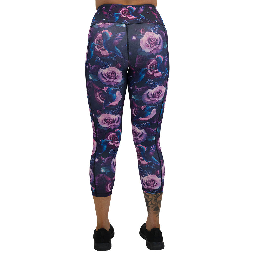 back of the leggings with a design of a blue hummingbird and pink roses