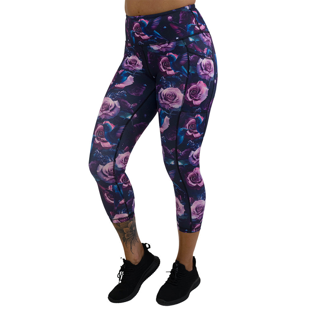 leggings with a design of a blue hummingbird and pink roses