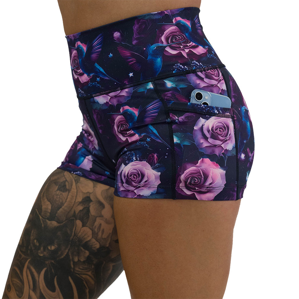 shorts with a design of a blue hummingbird and pink roses