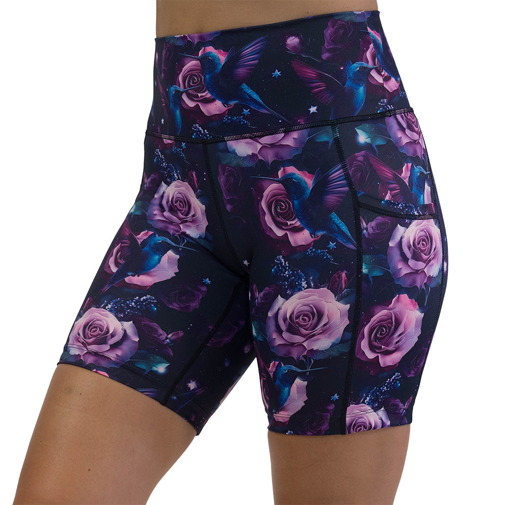 shorts with a design of a blue hummingbird and pink roses