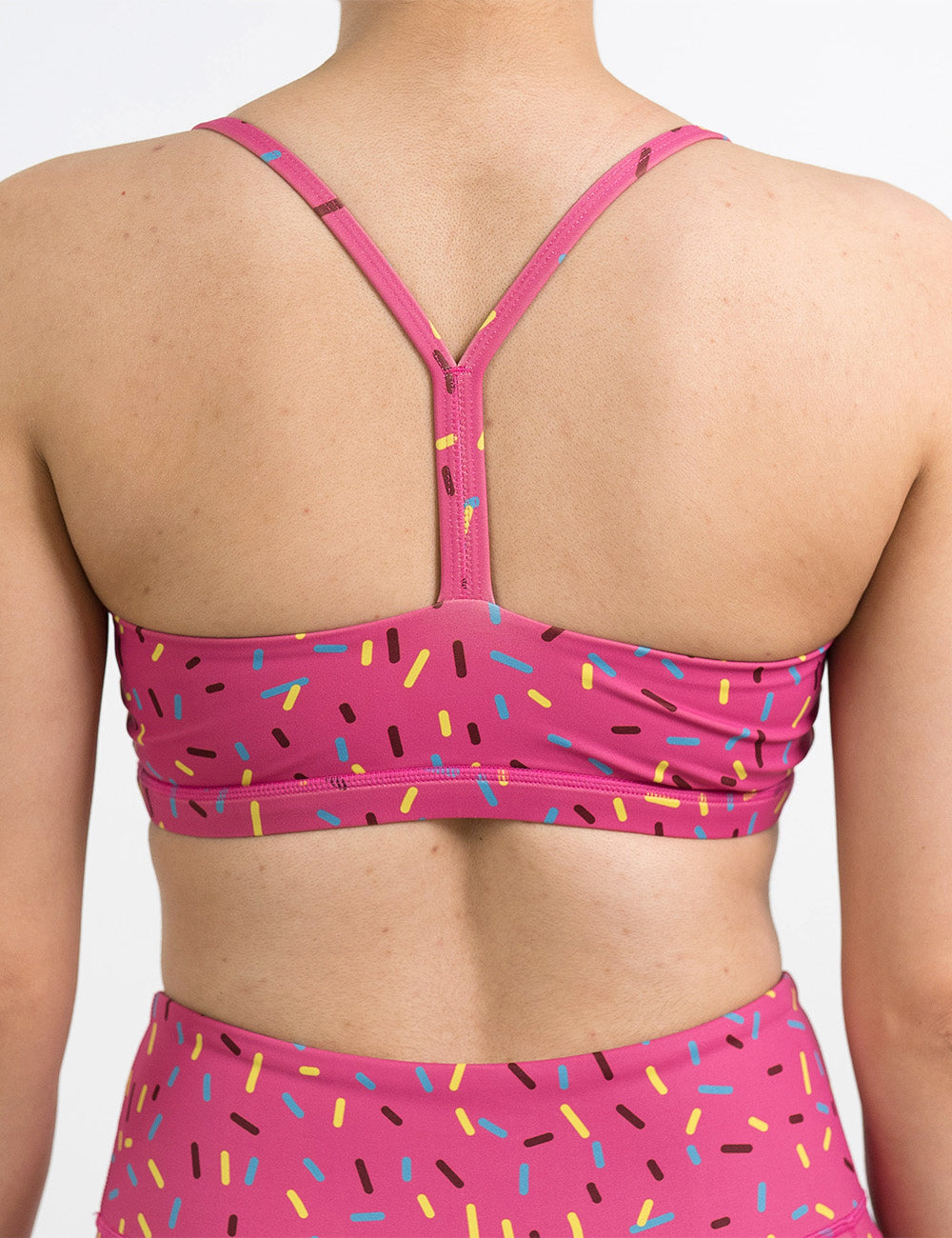 back of the pink move free bra with a sprinkles pattern against a white background